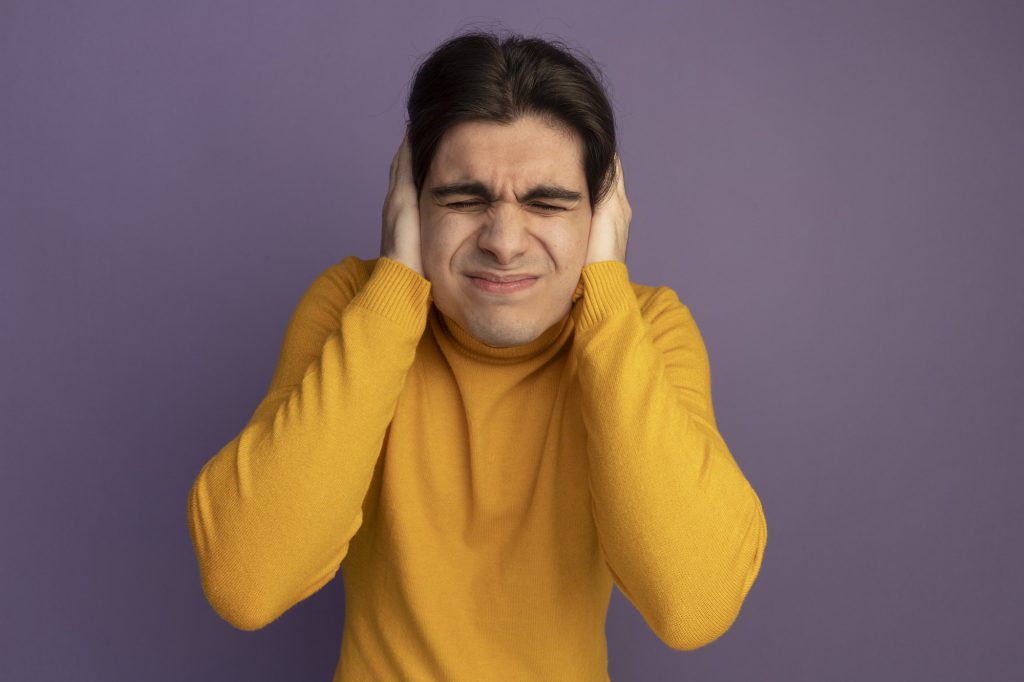 unpleased with closed eyes young handsome guy wearing yellow turtleneck sweater putting hands ears isolated purple wall 141793 91720
